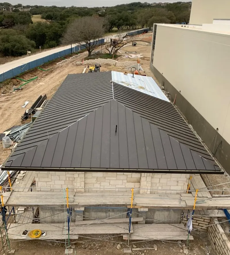 Metal roof new construction with scaffolding in Westgate